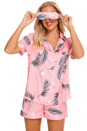 Pink botanical print satin pajama set with button-down top and shorts.