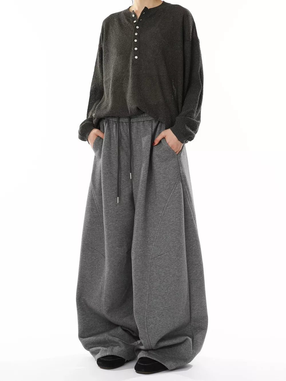 Men's gray wide-leg sweatpants with drawstring waist and pockets.