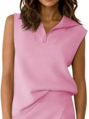 Pink sleeveless quarter-zip top and skort ensemble with a collar and asymmetrical detail.