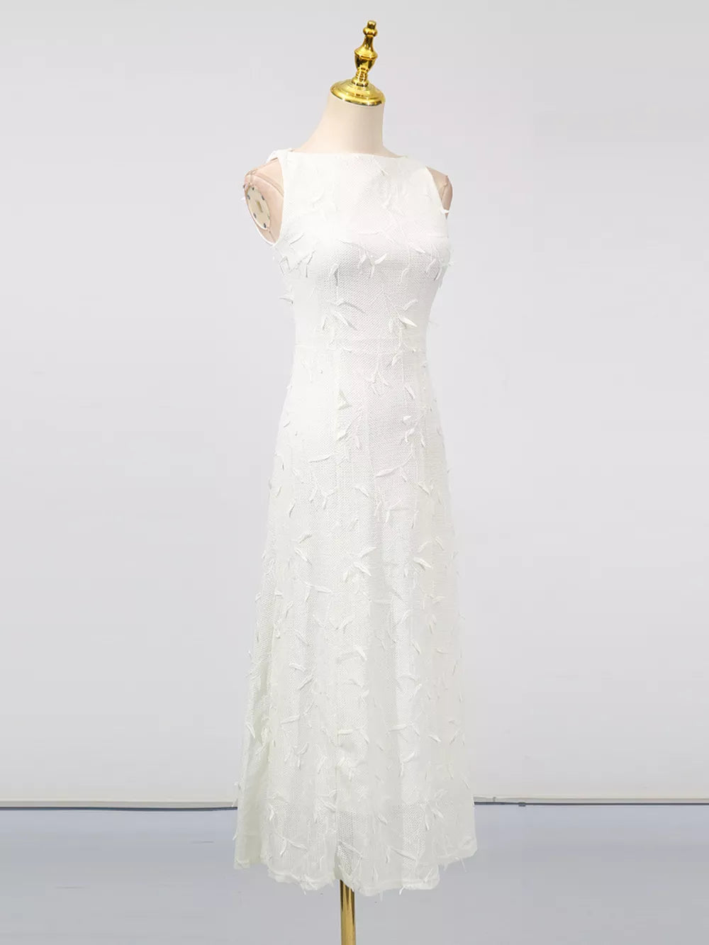White A-line midi dress with floral applique and boat neck.