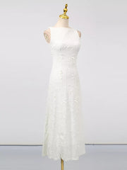 White A-line midi dress with floral applique and boat neck.
