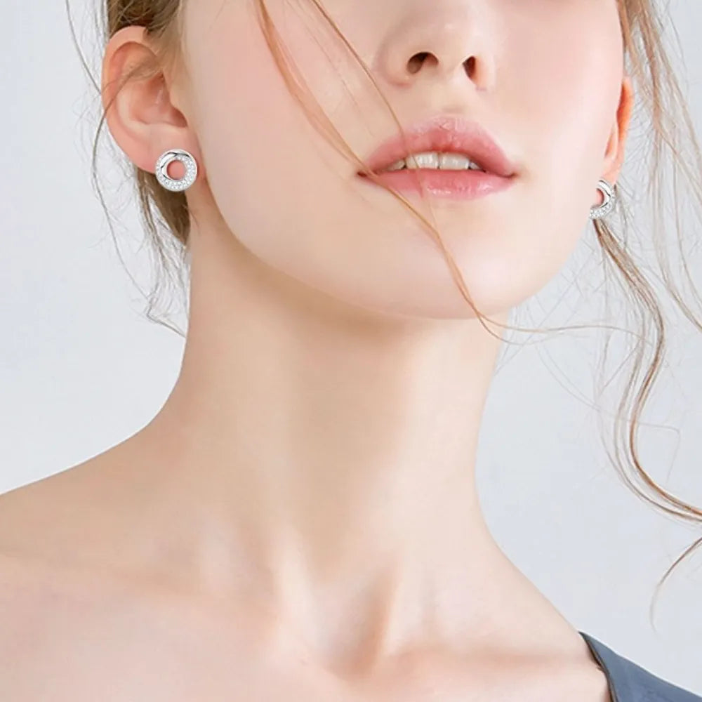 Silver pavé circle stud earrings with a delicate, open design.