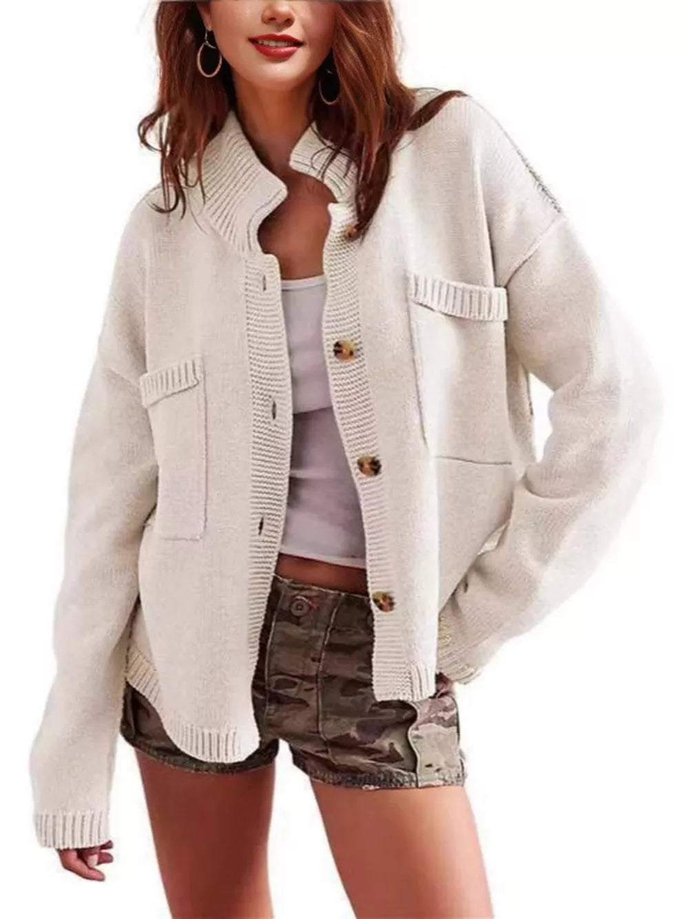 Ivory knit cardigan with button front, pockets, and ribbed collar.