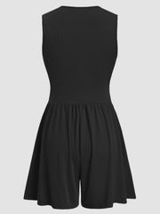 Black ribbed plunge romper with a gathered waist and flared shorts.