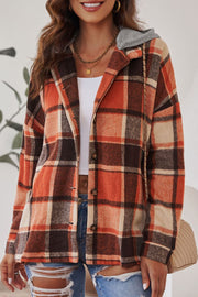 Plaid hooded shacket in orange, tan, and brown with button front and relaxed fit.