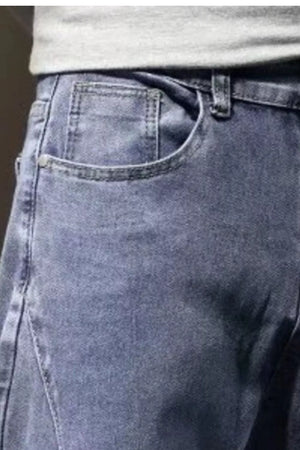 Relaxed fit straight leg jeans in medium wash cotton with classic pocket details.