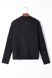 Black textured bouclé open-front jacket with a rounded neckline and long sleeves.