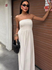 Beige smocked bodice relaxed maxi dress with a strapless neckline.
