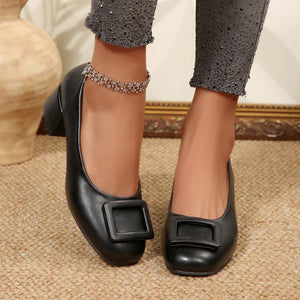 Black buckle block heel shoes with a square toe and chunky heel.