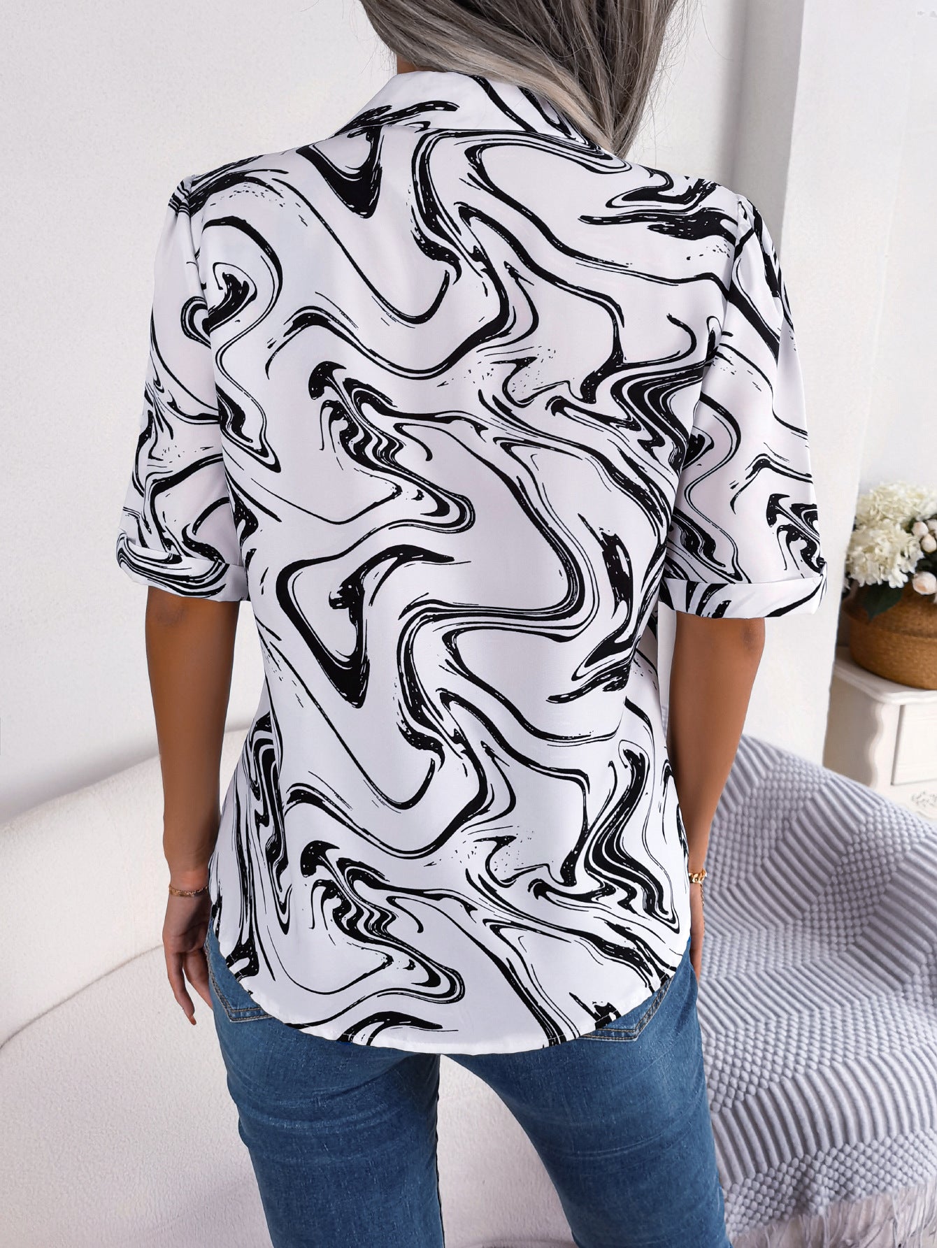 White swirl print camp collar blouse with short sleeves.