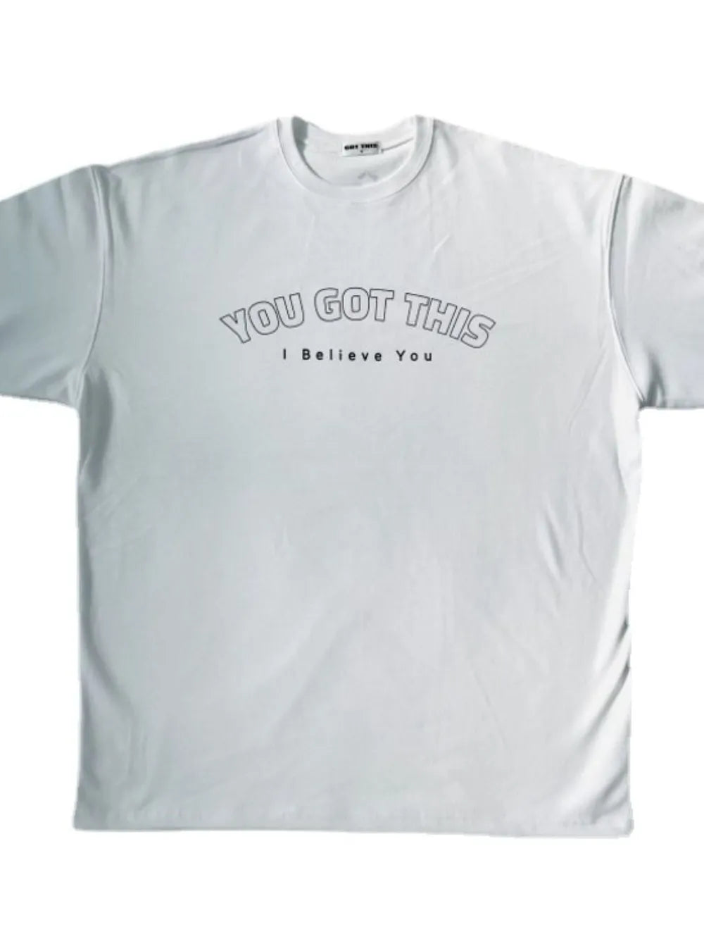 White oversized tee with "YOU GOT THIS I Believe You" graphic print