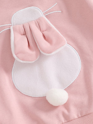 Pink cotton baby outfit with bunny applique, ears, and pom-pom tail.