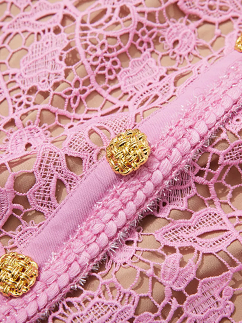 Pink lace midi dress with button details and textured trim.