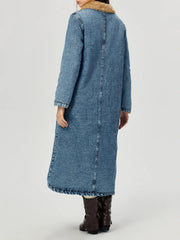 Denim maxi coat in medium wash with shearling trim on collar and cuffs.