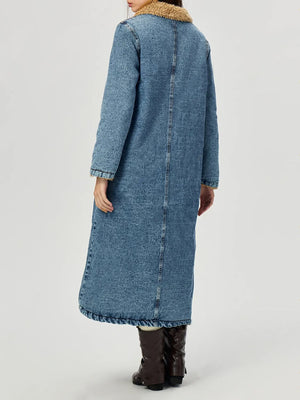 Denim maxi coat in medium wash with shearling trim on collar and cuffs.