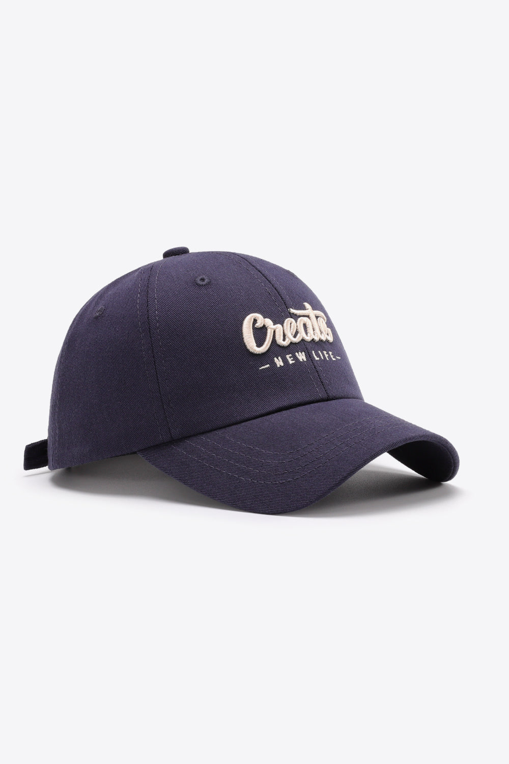 Navy baseball cap with embroidered "Create New Life" text and adjustable strap.