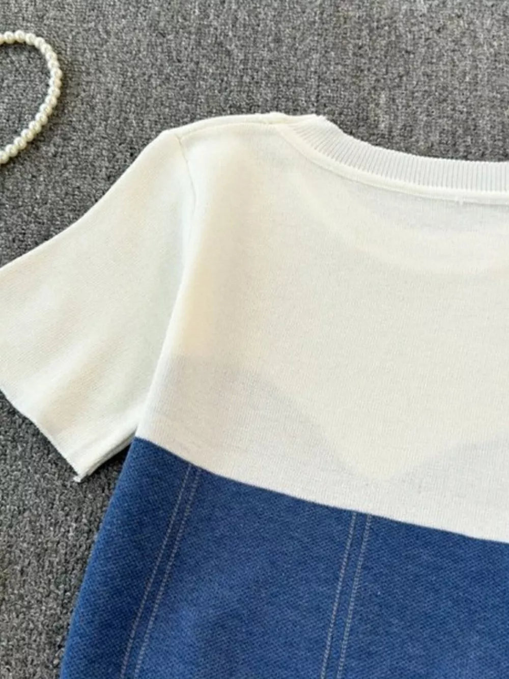 Color block knit t-shirt in white with blue, featuring ribbed neckline and short sleeves.