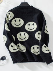 Black intarsia knit sweater with allover smiley face pattern and crewneck.