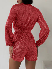 Sequin wrap romper in scarlet with blouson sleeves and elastic waist.