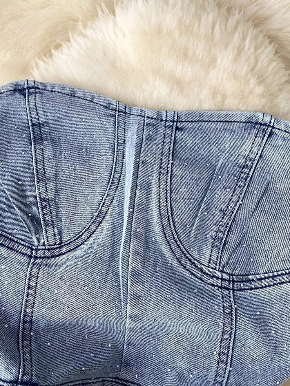 Blue denim bustier bodysuit with allover rhinestones and corset seams