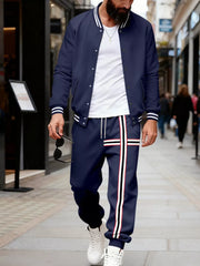 Navy blue tracksuit set with white stripes on jacket sleeves and pants.