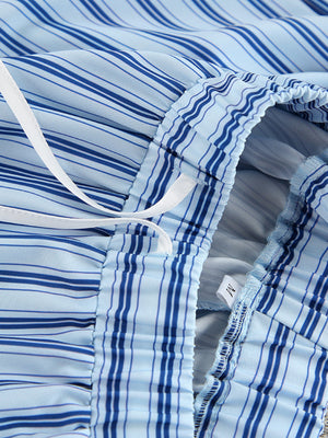 Blue striped pajama shorts with drawstring waist and ruffled hem detail.