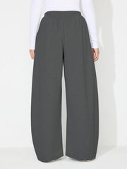 Dark gray pleated drape palazzo trousers with a comfortable elastic waistband.