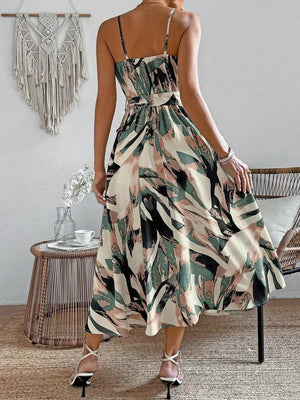 Vibrant abstract print cami dress with a belted waist and midi hem in fuchsia pink, army green, and cream.