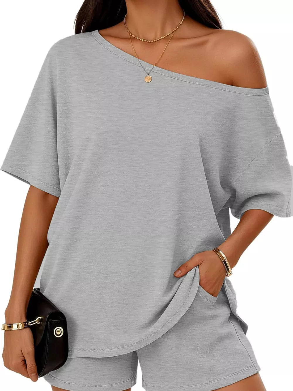 Light gray asymmetrical one-shoulder top with pockets and matching shorts set.