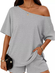 Light gray asymmetrical one-shoulder top with pockets and matching shorts set.