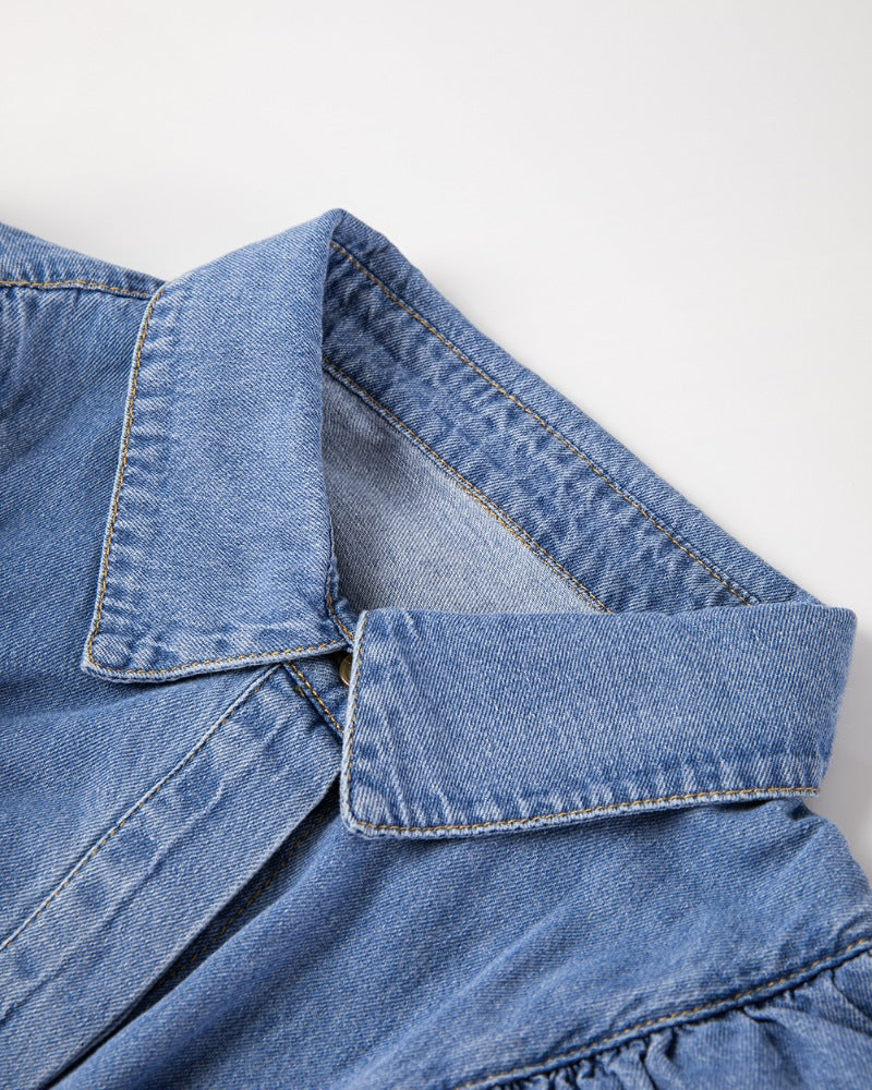 Denim ruffle yoke shirt in medium wash cotton with a collar detail.