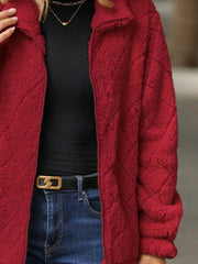 Deep Red textured teddy zip-up jacket with a diamond pattern, styled with a black top and jeans.