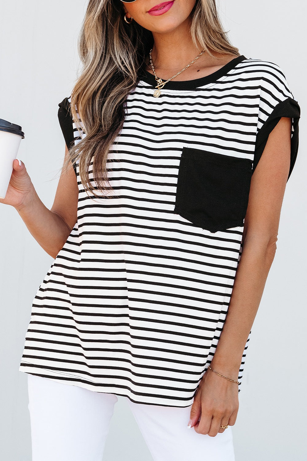 Black and white striped t-shirt with a black pocket detail and crew neck.