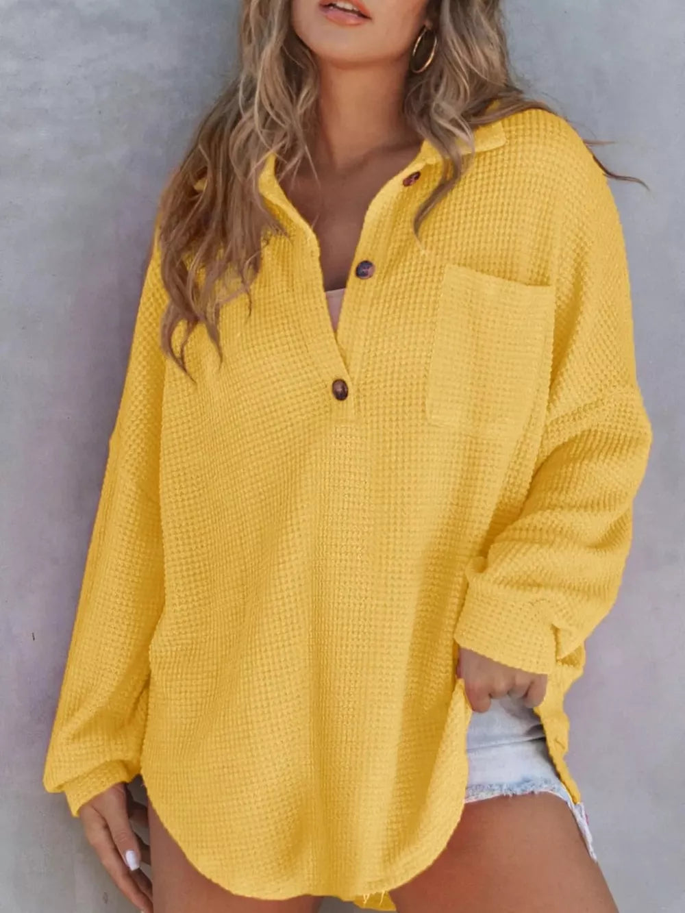 Yellow waffle-knit henley tee with pocket and button detail.