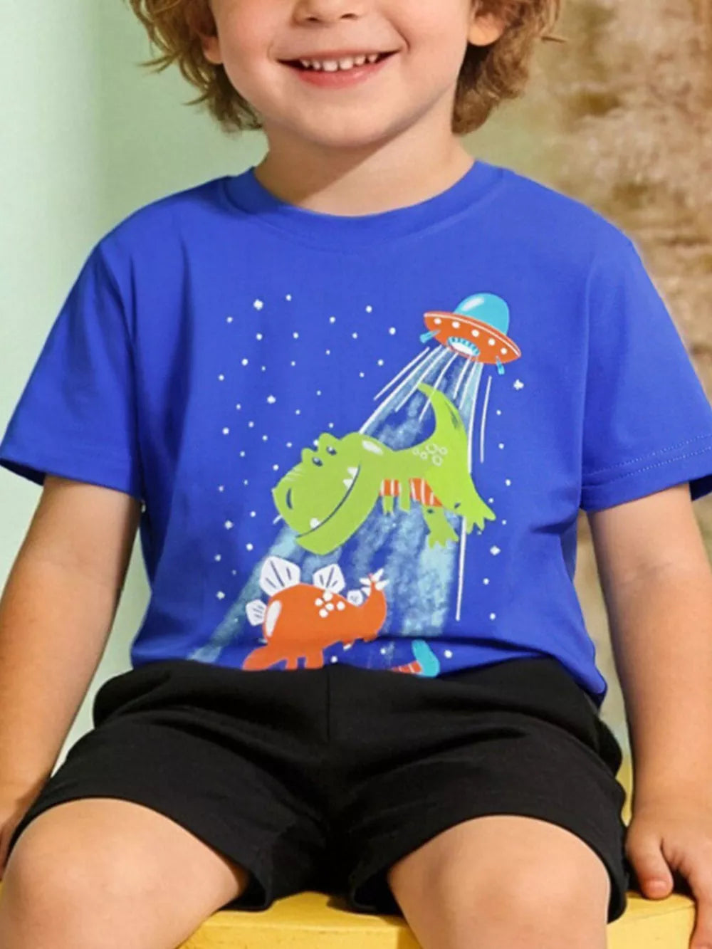 Playful Dinosaur and UFO graphic tee, cotton crew neck t-shirt for babies and children.