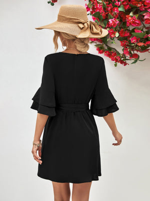 Black tiered sleeve mini dress with tie waist and A-line skirt.
