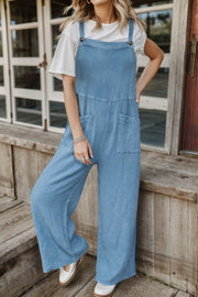 Light blue textured cotton overalls with square pockets and wide legs.