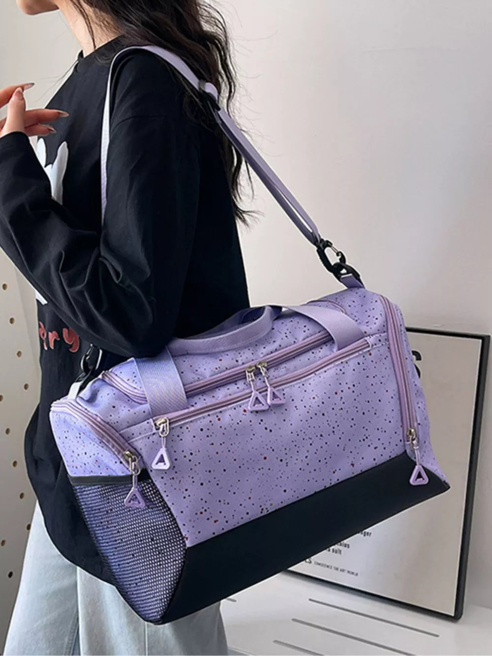 Chic speckled lavender travel bag with black contrast base and mesh side pocket.