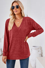 Relaxed V-neck tunic top in rust heather with long sleeves and a slouchy fit.