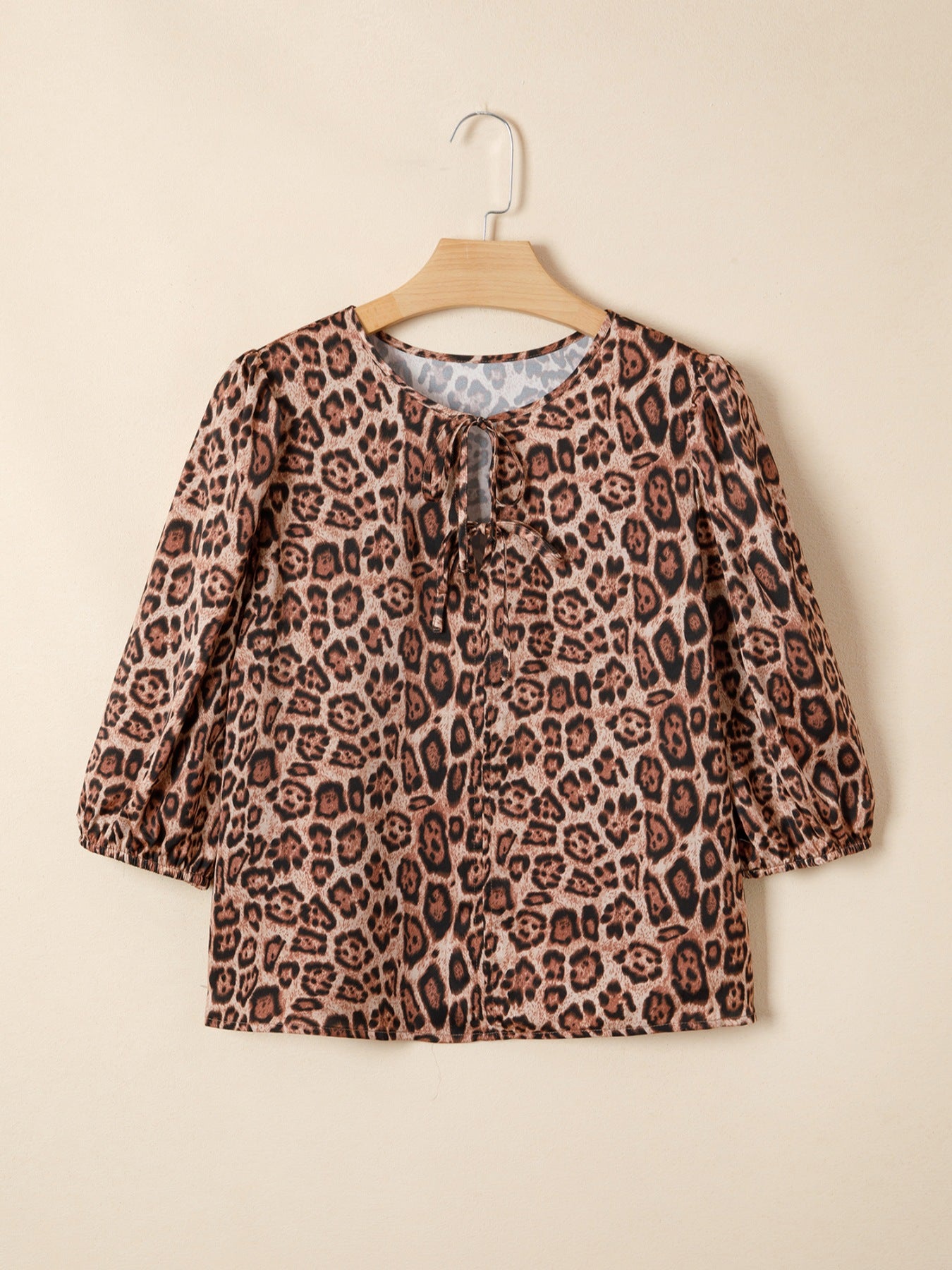 Leopard print blouse with puff sleeves and a tie-neck detail