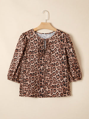 Leopard print blouse with puff sleeves and a tie-neck detail