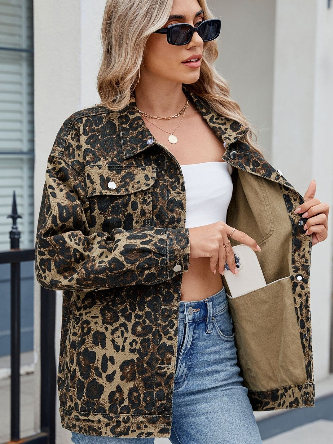 Leopard print utility denim shacket with chest pockets and a removable hood.