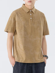 Brown cotton polo shirt with subtle texture and buttoned placket.