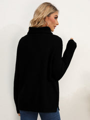 Black textured knit oversized turtleneck pullover sweater with ribbed details.
