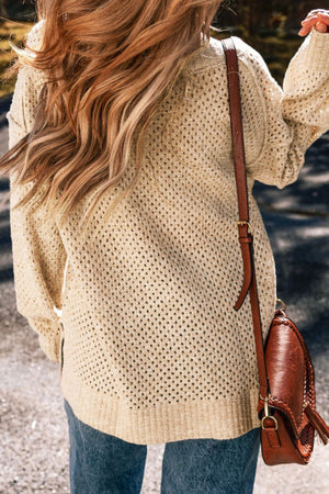 Beige open-knit slouchy V-neck sweater with textured detail.