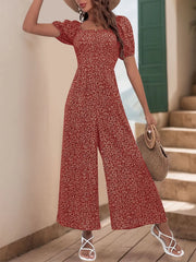 Smocked bodice floral print jumpsuit with puff sleeves and wide legs.