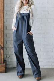 Peacock blue corduroy wide-leg overalls with front pockets and button detail.