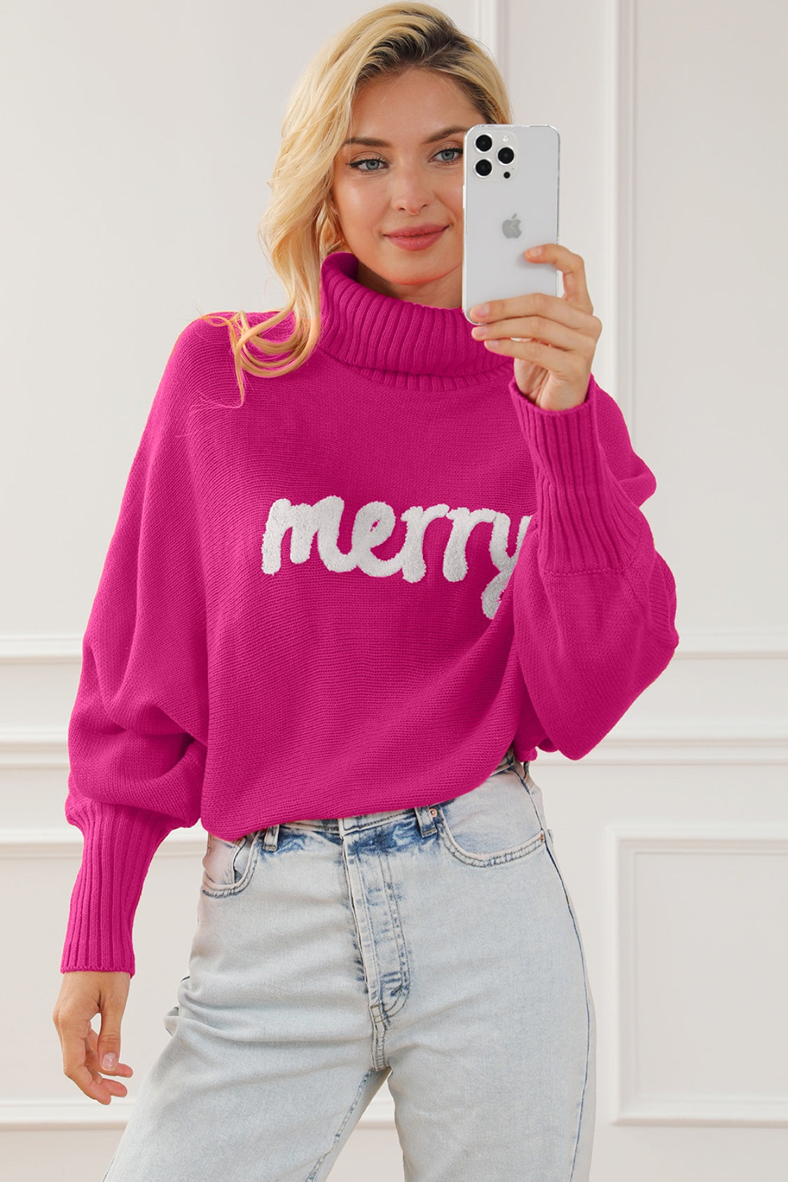 Pink acrylic turtleneck sweater with white "merry" graphic and dolman sleeves.