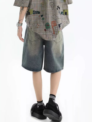 Relaxed fit denim shorts in vintage wash with a faded blue hue and distressed details.
