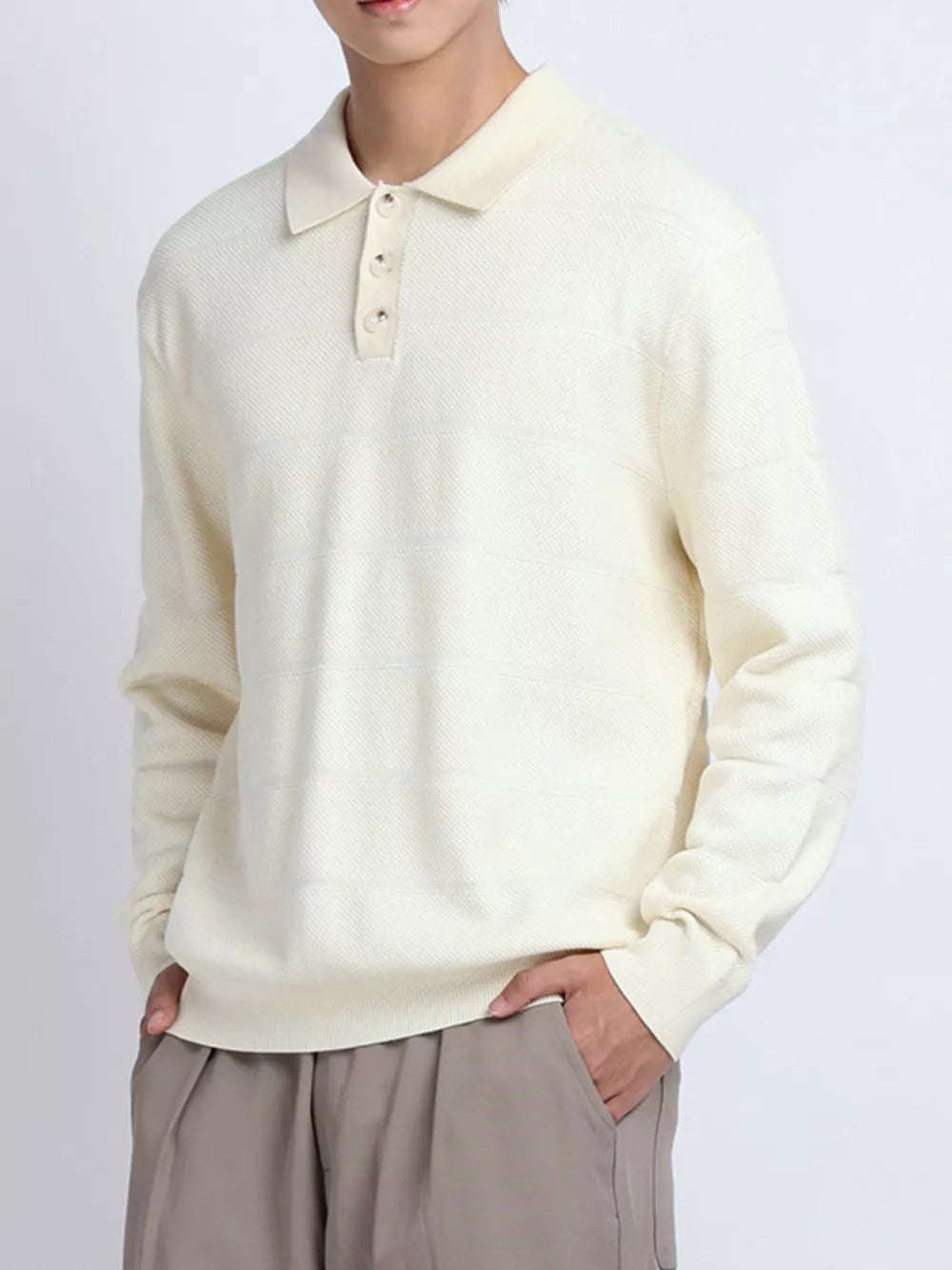 Apricot knit polo shirt with button accents and subtle horizontal stripe texture.